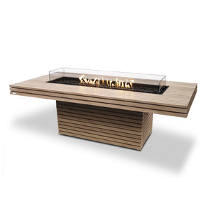The EcoSmart Fire Gin 90 Dining Height Teak outdoor fire table offers an elegant teak wood design with a premium stainless steel burner. Its sleek rectangular structure provides ample surface space, making it ideal for outdoor dining spaces. The long gas fire pit delivers a warm, inviting ambiance, making it a perfect addition to luxury fire pits for patios.