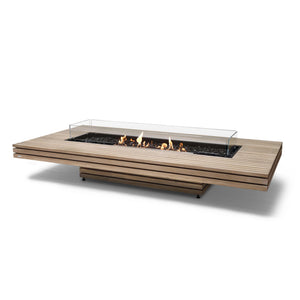The EcoSmart Fire Gin 90 Low Teak outdoor fire pit table features a sleek teak wood slatted design with a black burner and wind guard, providing a modern aesthetic for patios and outdoor living spaces. Designed for durability, this rectangular gas fire pit offers both natural gas and propane compatibility, making it a versatile addition to any outdoor entertainment area.