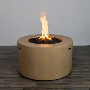 Front view of the Starfire Designs Beton 42" Sand Round Concrete Gas Fire Pit with a steady, bright flame glowing above the lava rocks. The sand-colored surface provides a modern yet natural appearance for any outdoor space.