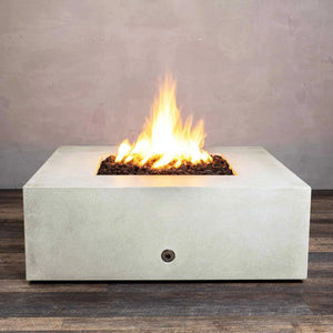 Starfire Designs Gravity 45-inch Square Concrete Gas Fire Pit in white, showcasing a large flame with lava rocks inside the fire bowl, perfect for outdoor patios. Durable and modern in design, this fire pit is ideal for contemporary outdoor spaces. Gas-powered for easy use, providing warmth and ambiance
