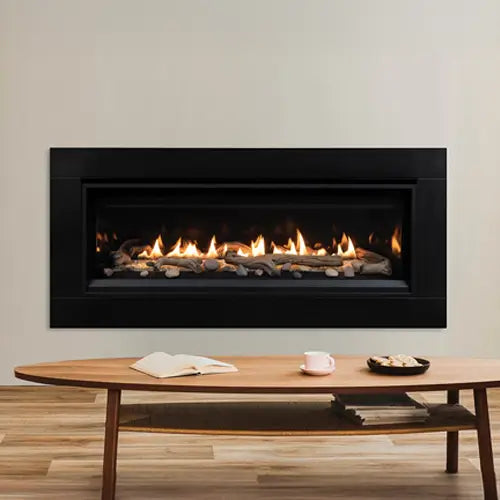 A stunning modern gas fireplace is installed in the wall of a simple livingroom with a simple table