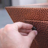 Close-up of 10ft Copper Spartan Gas Fire Pit control, showcasing detailed hand-hammered copper craftsmanship