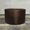 A side view of the 36" Round Gravity Powder Coated Steel Fire Pit - Natural Gas - Match Lit - Bronze Hammertone by Starfire Designs - perfect for outdoor patio spaces. Natural gas or propane compatible, enhancing warmth and ambiance. Lava rocks included for added aesthetic.