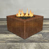 Front view of 36" Square Gravity Corten Steel Fire Pit - Propane Gas Hardline - 110V CSA Hi/Lo Electronic Ignition System w/Bluetooth & Handheld Remote by Starfire Designs - Brown with flames on, featuring sleek modern concrete design and durable construction, perfect for outdoor patio spaces. Natural gas or propane compatible, enhancing warmth and ambiance. Lava rocks included for added aesthetic.