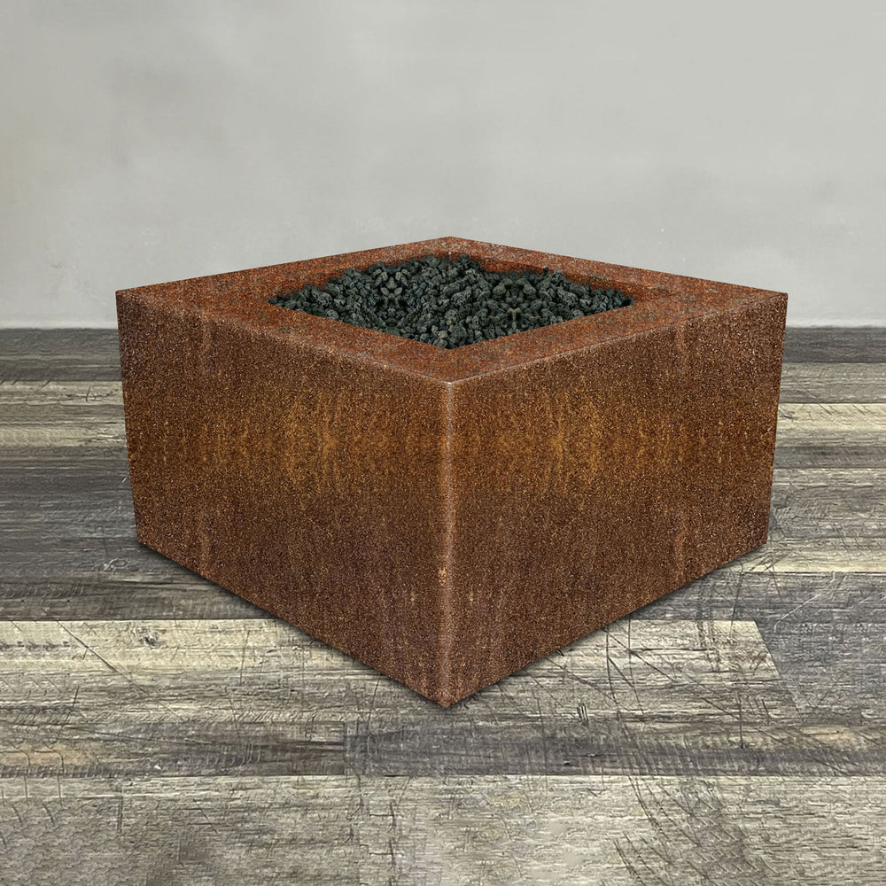 A side view of the 36" Square Gravity Corten Steel Fire Pit by Starfire Designs - perfect for outdoor patio spaces. Natural gas or propane compatible, enhancing warmth and ambiance. Lava rocks included for added aesthetic.