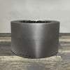 A side view of the 36" Round Gravity Powder Coated Steel Fire Pit - Natural Gas - Match Lit - Silver Hammertone by Starfire Designs - perfect for outdoor patio spaces. Natural gas or propane compatible, enhancing warmth and ambiance. Lava rocks included for added aesthetic.