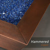 Close-up of the 40-inch Copper Canyon gas fire pit by Starfire Designs, highlighting the blue fire glass and hammered copper texture, ideal for luxury outdoor fire pits