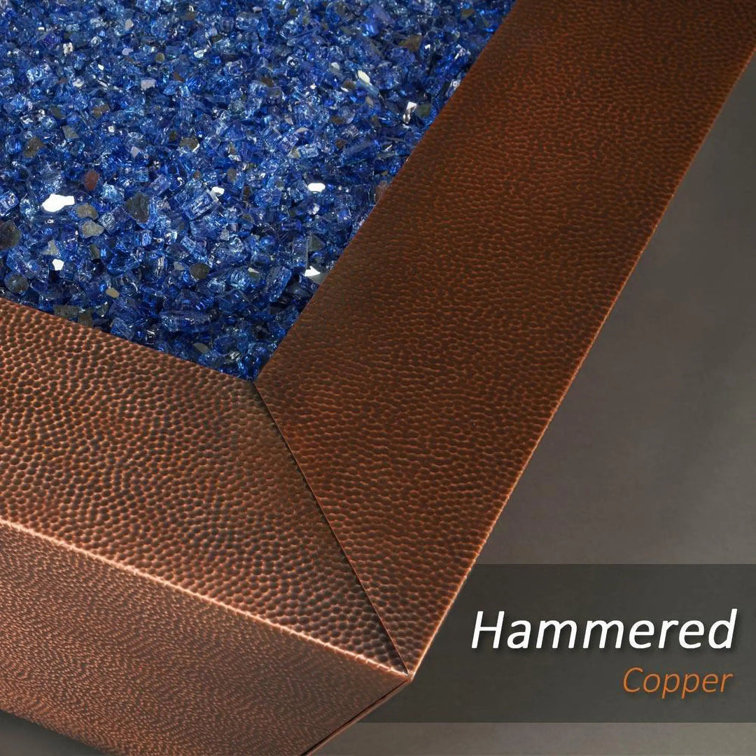 Close-up of the 40-inch Copper Canyon gas fire pit by Starfire Designs, highlighting the blue fire glass and hammered copper texture, ideal for luxury outdoor fire pits