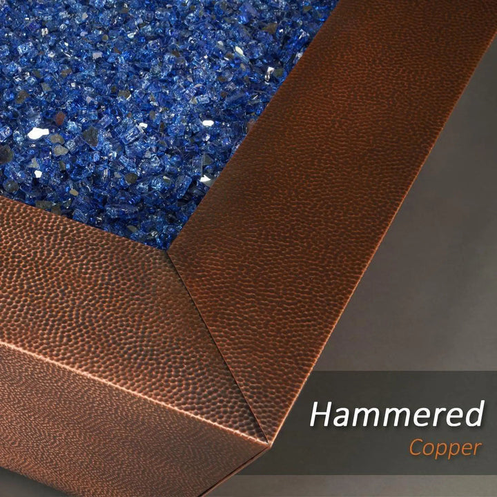 Close-up of the 40-inch Copper Canyon gas fire pit by Starfire Designs, highlighting the blue fire glass and hammered copper texture, ideal for luxury outdoor fire pits