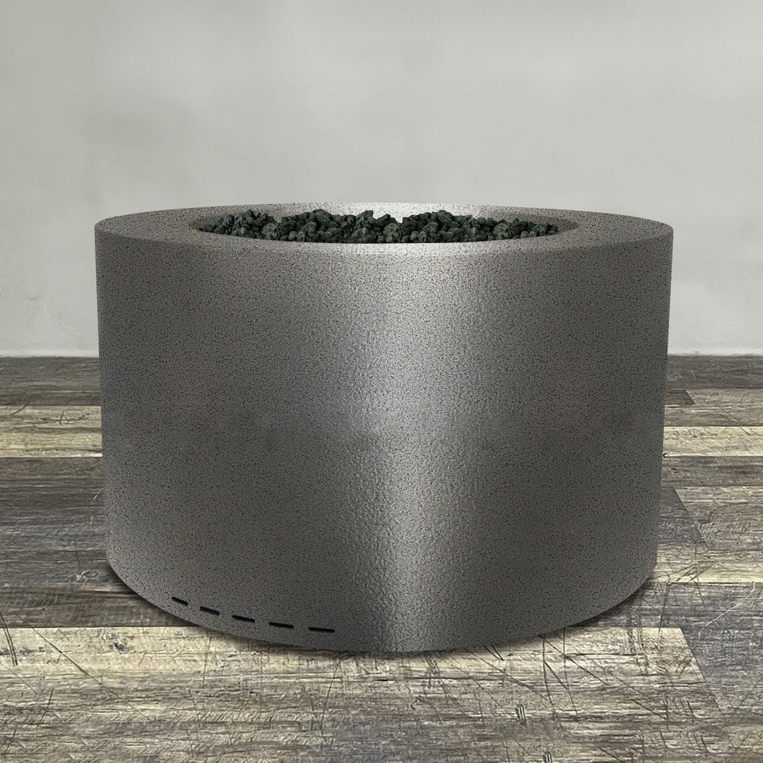 A side view of the 45" Round Gravity Powder Coated Steel Fire Pit - Natural Gas - 110V CSA Hi/Lo Electronic Ignition System w/Bluetooth & Handheld Remote - Silver Hammertone by Starfire Designs - perfect for outdoor patio spaces. Natural gas or propane compatible, enhancing warmth and ambiance. Lava rocks included for added aesthetic.