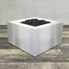 A side view of the 45" Square Gravity Stainless Steel Fire Pit by Starfire Designs - perfect for outdoor patio spaces. Natural gas or propane compatible, enhancing warmth and ambiance. Lava rocks included for added aesthetic.
