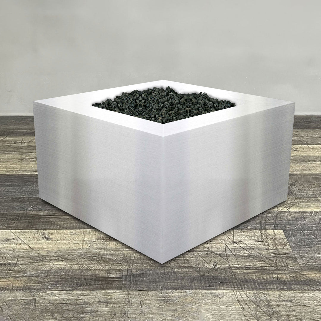 A side view of the 45" Square Gravity Stainless Steel Fire Pit by Starfire Designs - perfect for outdoor patio spaces. Natural gas or propane compatible, enhancing warmth and ambiance. Lava rocks included for added aesthetic.
