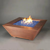 48-inch Copper Canyon gas fire pit by Starfire Designs, emphasizing the blue fire glass and textured hammered copper, ideal for luxury modern fire pits