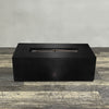A side view of the 48" x 24" Rectangle Gravity Powder Coated Steel Fire Pit - Natural Gas - 110V Electronic Ignition System - Black Hammertone by Starfire Designs - perfect for outdoor patio spaces. Natural gas or propane compatible, enhancing warmth and ambiance. Lava rocks included for added aesthetic.