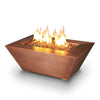 Starfire Designs 48" x 32" Copper Canyon gas fire pit with golden fire glass, featuring a hammered copper finish, perfect for luxury outdoor fire pits