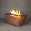 48" x 32" Copper Canyon gas fire pit by Starfire Designs, enhancing an outdoor patio setting, with a hammered copper finish, perfect for luxurious outdoor living spaces