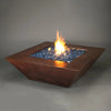 50-inch Plaza Moreno copper fire pit with blue fire glass and glowing flames, perfect for luxury outdoor fire pits in modern backyard settings by Starfire Designs