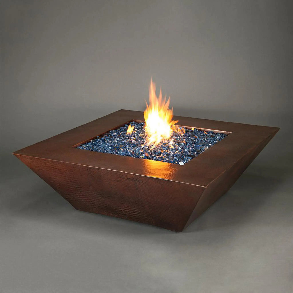 50-inch Plaza Moreno copper fire pit with blue fire glass and glowing flames, perfect for luxury outdoor fire pits in modern backyard settings by Starfire Designs