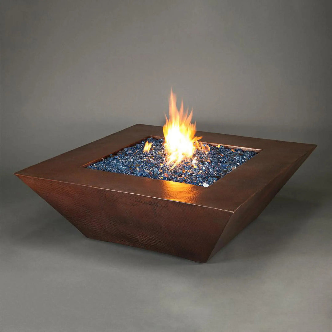 50-inch Plaza Moreno copper fire pit with blue fire glass and glowing flames, perfect for luxury outdoor fire pits in modern backyard settings by Starfire Designs