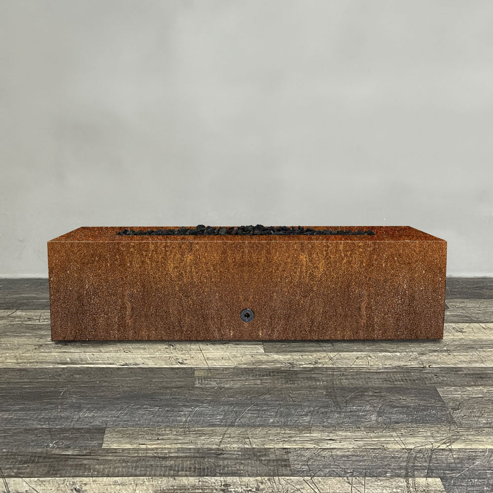 A side view of the 60" x 24" Rectangle Gravity Corten Steel Fire Pit - Propane Gas Hardline - 110V CSA Hi/Lo Electronic Ignition System w/Bluetooth & Handheld Remote by Starfire Designs - perfect for outdoor patio spaces. Natural gas or propane compatible, enhancing warmth and ambiance. Lava rocks included for added aesthetic.
