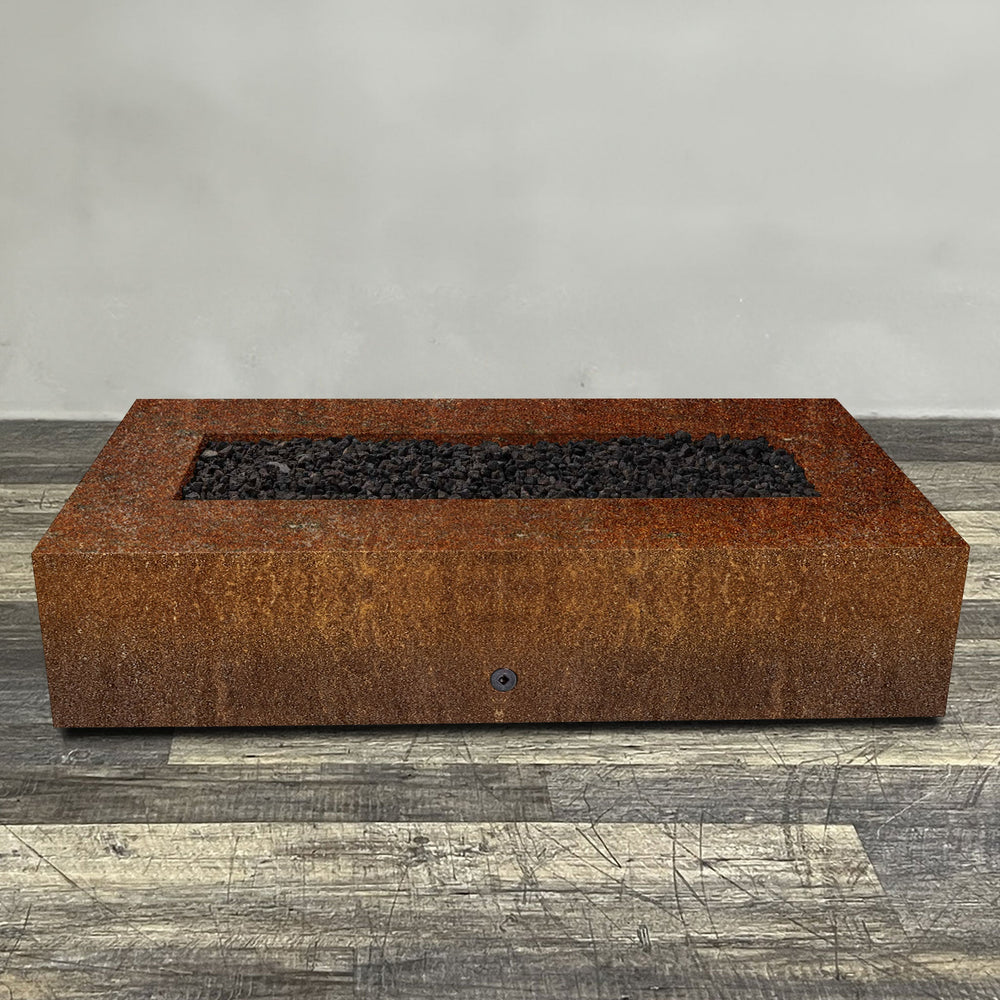 A side view of the 72" x 38" Rectangle Gravity Corten Steel Fire Pit by Starfire Designs - perfect for outdoor patio spaces. Natural gas or propane compatible, enhancing warmth and ambiance. Lava rocks included for added aesthetic.