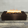 A side view of the 72" x 38" Rectangle Gravity Powder Coated Steel Fire Pit - Propane Gas Hardline - 110V CSA Hi/Lo Electronic Ignition System w/Bluetooth & Handheld Remote - Bronze Hammertone by Starfire Designs - perfect for outdoor patio spaces. Natural gas or propane compatible, enhancing warmth and ambiance. Lava rocks included for added aesthetic.