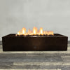 Front view of 72" x 38" Rectangle Gravity Powder Coated Steel Fire Pit - Propane Gas Hardline - 110V CSA Hi/Lo Electronic Ignition System w/Bluetooth & Handheld Remote - Copper Vein by Starfire Designs - Brown with flames on, featuring sleek modern concrete design and durable construction, perfect for outdoor patio spaces. Natural gas or propane compatible, enhancing warmth and ambiance. Lava rocks included for added aesthetic.