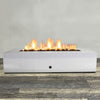 Front view of 72" x 38" Rectangle Gravity Stainless Steel Fire Pit - Natural Gas - Match Lit by Starfire Designs - Brown with flames on, featuring sleek modern  design and durable construction, perfect for outdoor patio spaces. Natural gas or propane compatible, enhancing warmth and ambiance. Lava rocks included for added aesthetic.