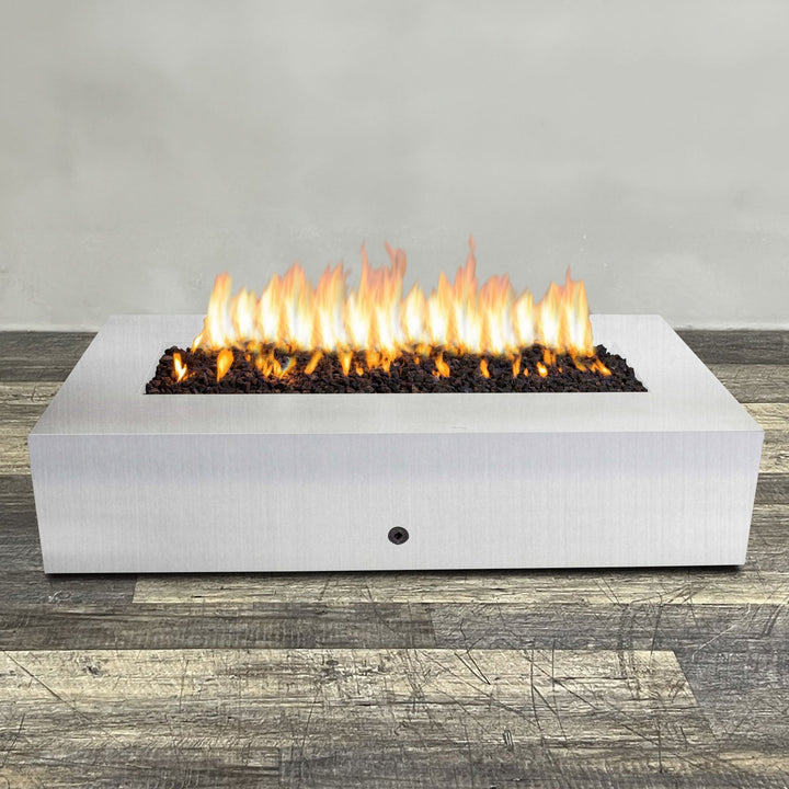 A side view of the 72" x 38" Rectangle Gravity Stainless Steel Fire Pit by Starfire Designs - perfect for outdoor patio spaces. Natural gas or propane compatible, enhancing warmth and ambiance. Lava rocks included for added aesthetic.
