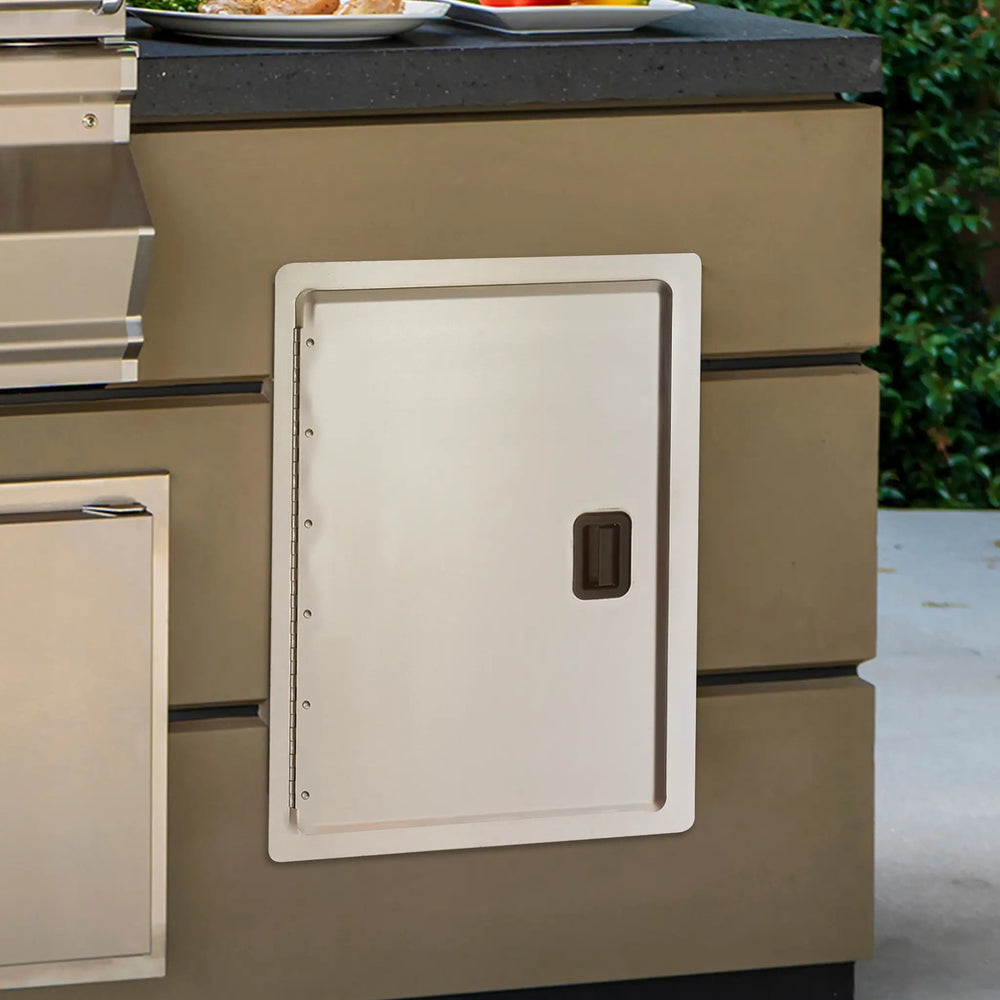 Closeup of a Fire Magic 12.5 x 18.5 Legacy Single Access Door built into an outdoor kitchen setup