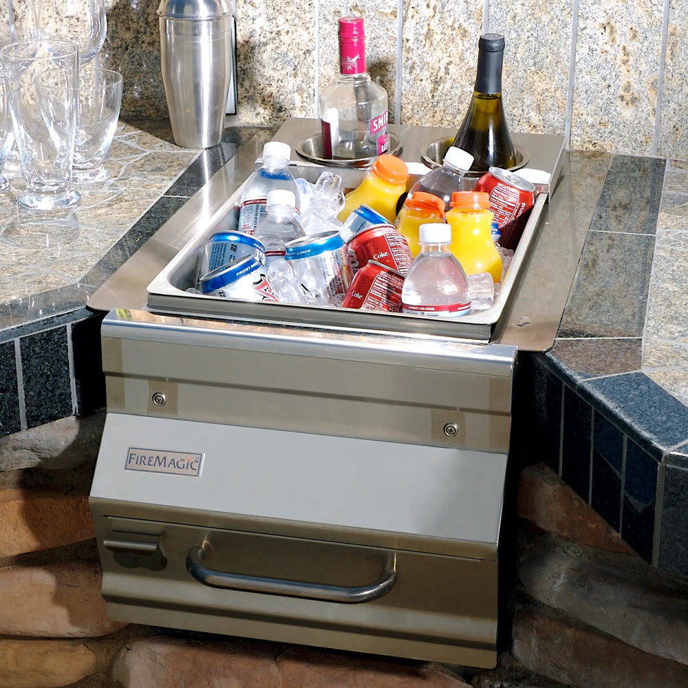 Fire Magic Bar Caddy installed into an outdoor kitchen space filled with soda, water, and alchoholic drinks.