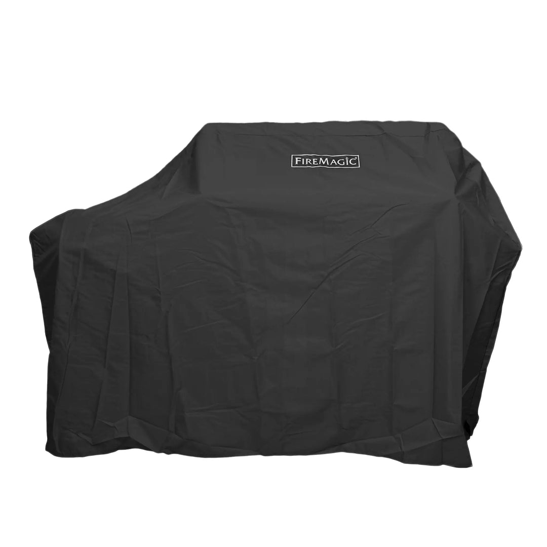 Fire Magic E790 Portable Grill Vinyl Cover covering a BBQ grill on a white background.
