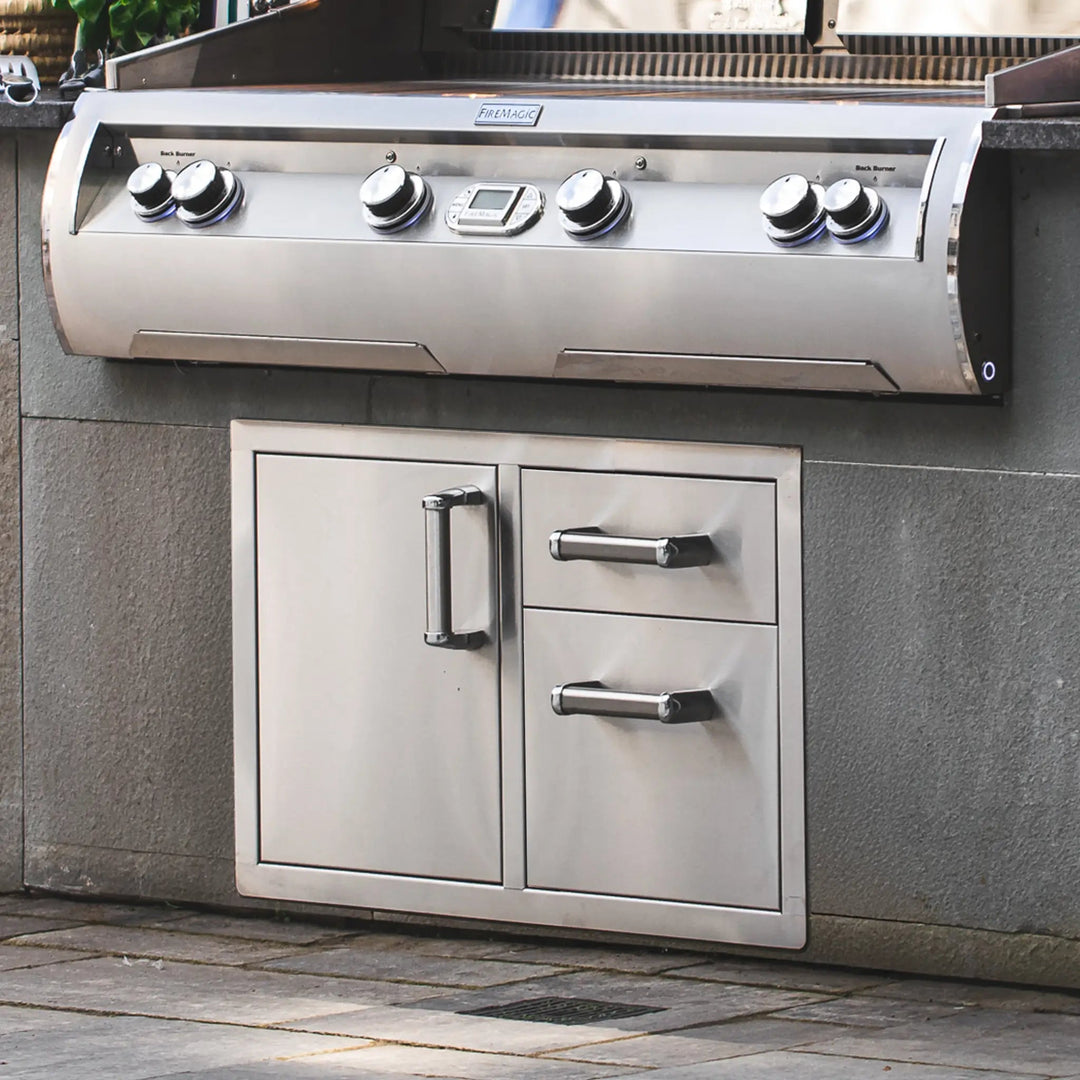 Fire Magic Premium Access Door with Double Drawers installed beneath a very large grill from Fire Magic in an outdoor kitchen patio