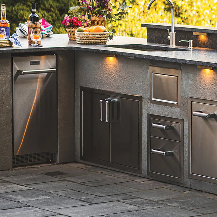 Fire Magic Premium Double Doors with Tank Tray, Louvers and Dual Drawers installed beneath a stunning outdoor kitchen setup
