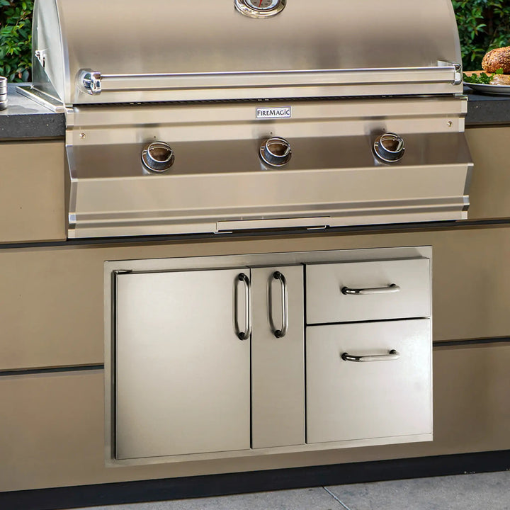 Fire Magic Select Access Door with Platter Storage and Double Drawers installed into a stone outdoor kitchen area.