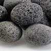 Close-up of medium gray lava stones with naturally porous texture—durable fire media ideal for boosting airflow and enhancing flame performance in gas fire pits and fireplaces.