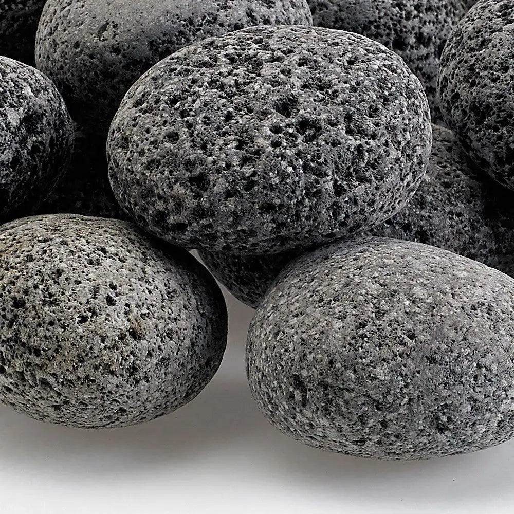 Close-up of medium gray lava stones with naturally porous texture—durable fire media ideal for boosting airflow and enhancing flame performance in gas fire pits and fireplaces.