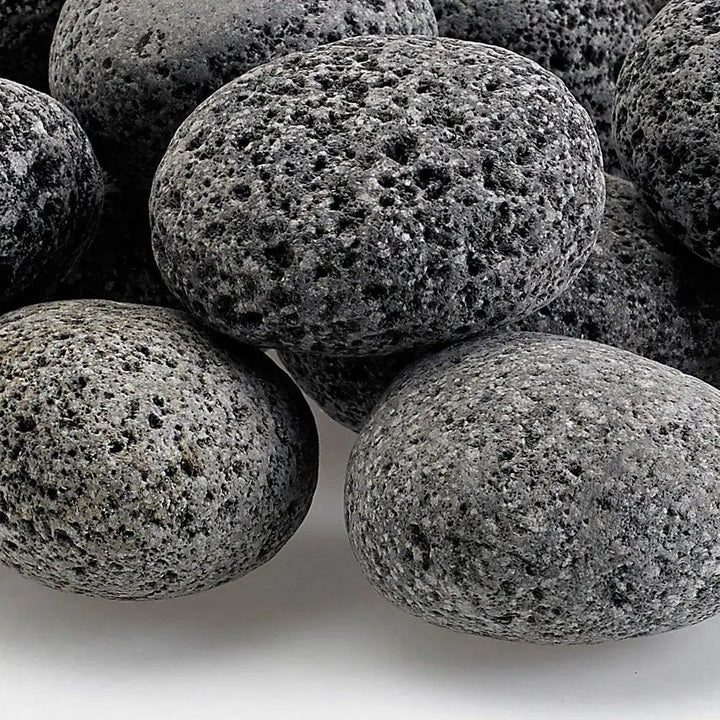Close-up of medium gray lava stones with naturally porous texture—durable fire media ideal for boosting airflow and enhancing flame performance in gas fire pits and fireplaces.