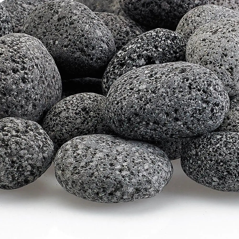 Close-up of small gray lava stones with a naturally porous surface—durable and decorative volcanic rock ideal for enhancing flame movement and airflow in gas fire features.