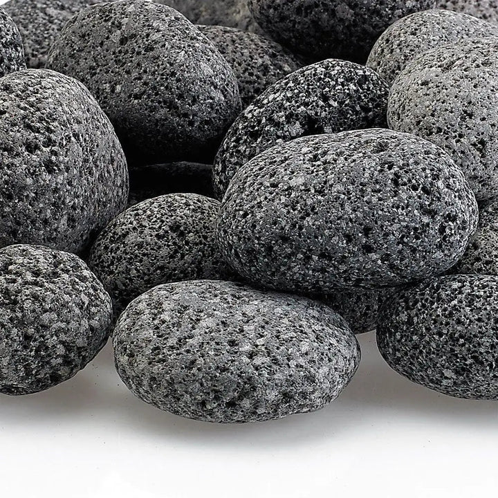 Close-up of small gray lava stones with a naturally porous surface—durable and decorative volcanic rock ideal for enhancing flame movement and airflow in gas fire features.
