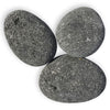 Three large, smooth-surfaced black lava stones from the XL collection by Starfire Direct—perfect for enhancing the look of fire pits or fireplaces with natural texture and lasting heat resistance.