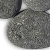 Close-up of extra-large black lava stones featuring a naturally rough, porous texture—ideal for bold, modern fire pit designs and superior heat performance.