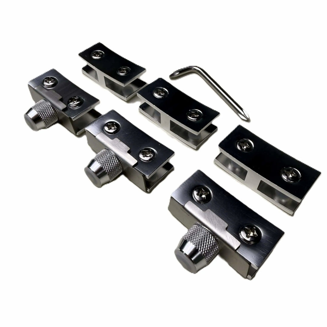 Close-up of the Starfire Designs Béton Fire Pit Replacement Round Glass Wind Guard Clips Kit showing four stainless steel clips with adjustment knobs and an included hex key tool.