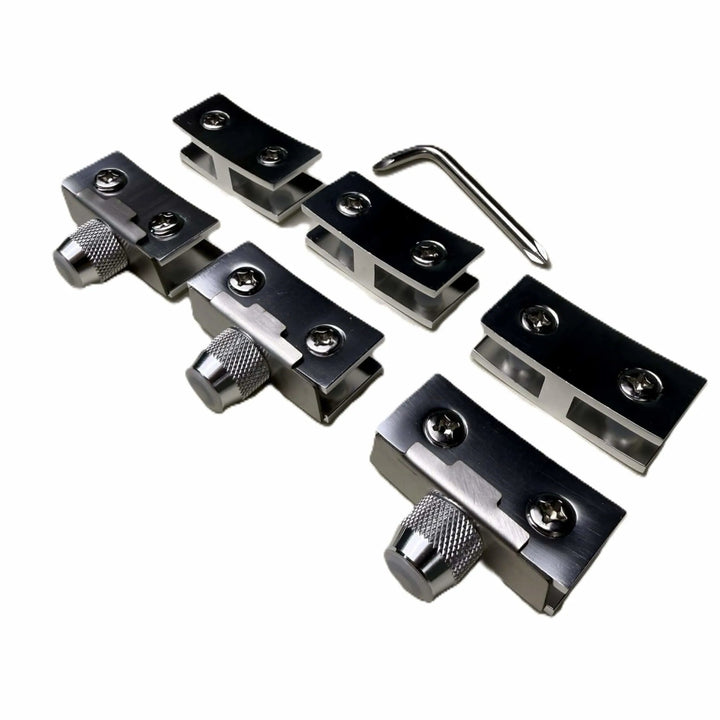 Close-up of the Starfire Designs Béton Fire Pit Replacement Round Glass Wind Guard Clips Kit showing four stainless steel clips with adjustment knobs and an included hex key tool.