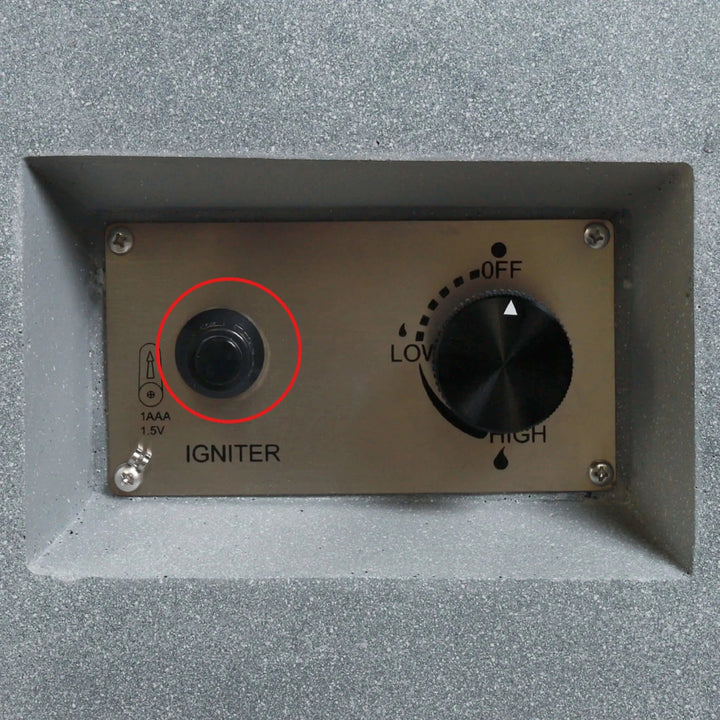 Installed Starfire Designs Béton Fire Pit Spark Button on the control panel, circled to highlight its placement next to the flame control knob for convenient ignition.