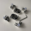 Top view of the Starfire Designs Béton Fire Pit Replacement Glass Wind Guard Clips Kit featuring precision-milled L-shaped clips, mounting hardware, and adjustment tools for rectangular or square guards.