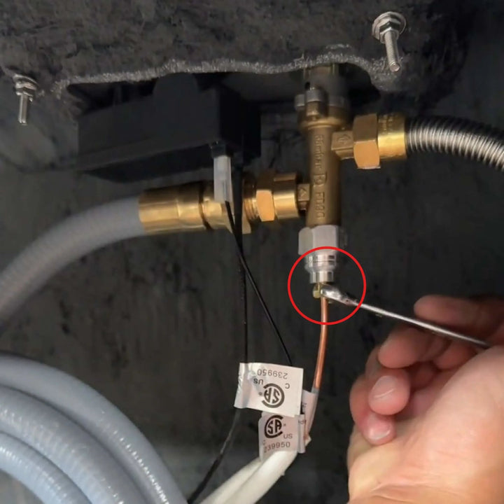 Installed view of the Starfire Designs Béton Fire Pit Thermocouple Wire connected to gas components beneath the fire pit, highlighting safe and professional installation.