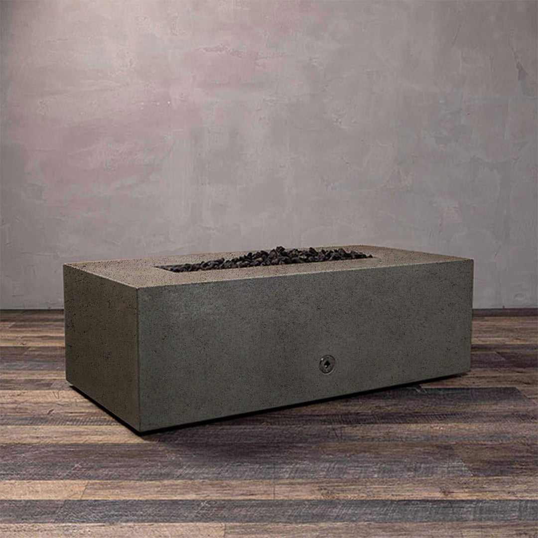 A side view of the Starfire Designs Gravity 48" x 32" Rectangle Rustic Gravity Concrete (GFRC) Fire Pit - Propane Gas Hardline - Brown with flames on, featuring sleek modern concrete bowl design and durable construction, perfect for outdoor patio spaces. Natural gas or propane compatible, enhancing warmth and ambiance. Lava rocks included for added aesthetic.
