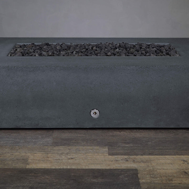 A side view of the Starfire Designs Gravity 72" x 38" Rectangle Rustic Gravity Concrete (GFRC) Fire Pit - Propane Gas Hardline - Graphite with flames on, featuring sleek modern concrete bowl design and durable construction, perfect for outdoor patio spaces. Natural gas or propane compatible, enhancing warmth and ambiance. Lava rocks included for added aesthetic.