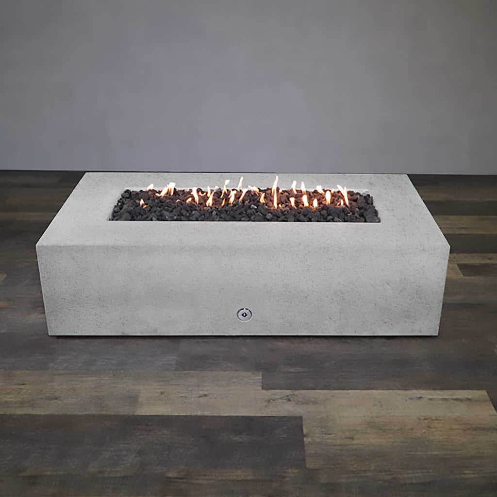 Front view of Starfire Designs Gravity 72" x 38" Rectangle Rustic Gravity Concrete (GFRC) Fire Pit - Propane Gas Hardline - White with flames on, featuring sleek modern concrete bowl design and durable construction, perfect for outdoor patio spaces. Natural gas or propane compatible, enhancing warmth and ambiance. Lava rocks included for added aesthetic.